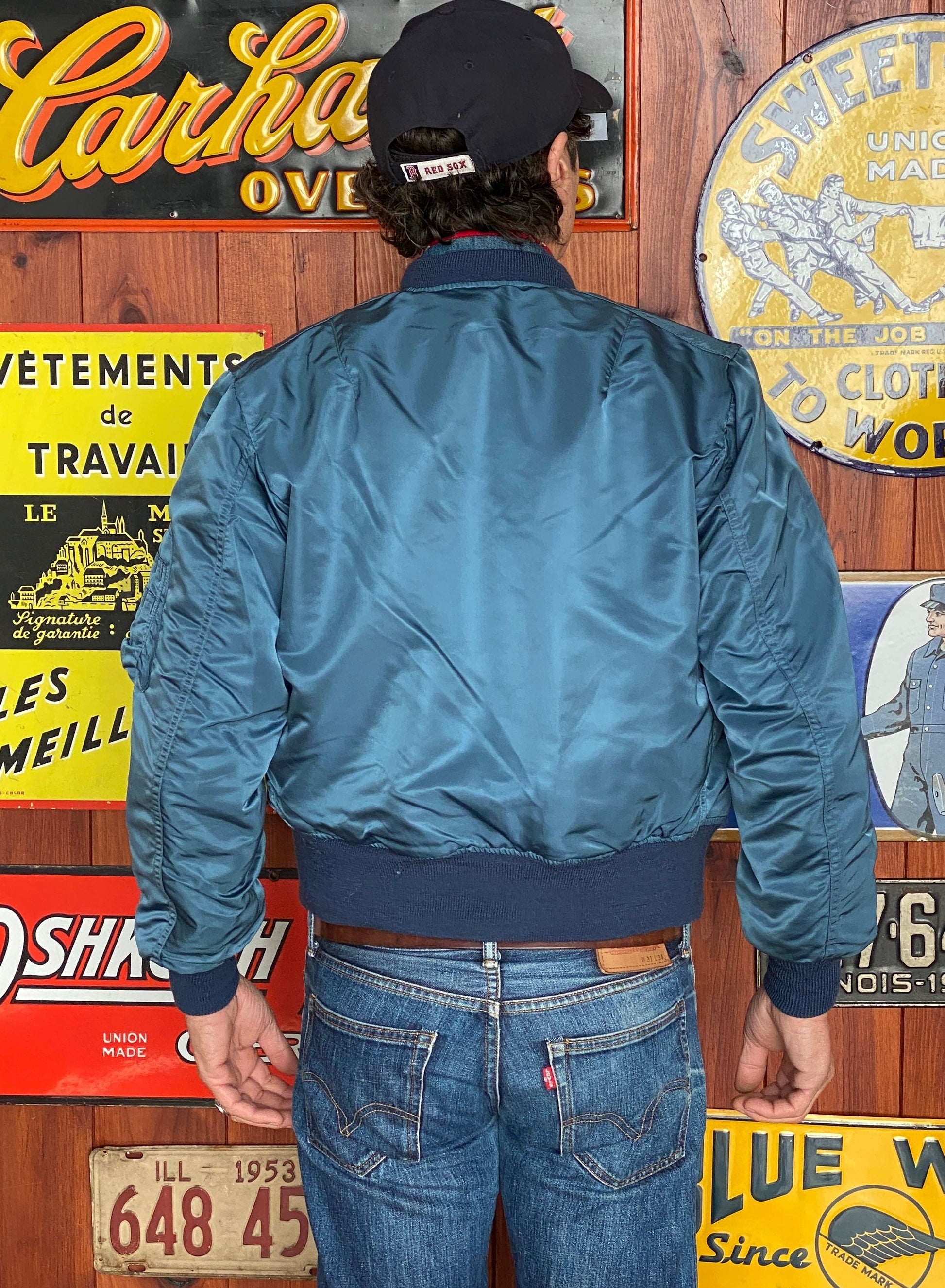 Vintage MA-1 flight bomber jacket by Weintraub Brothers, nylon shell with orange lining, size Small.