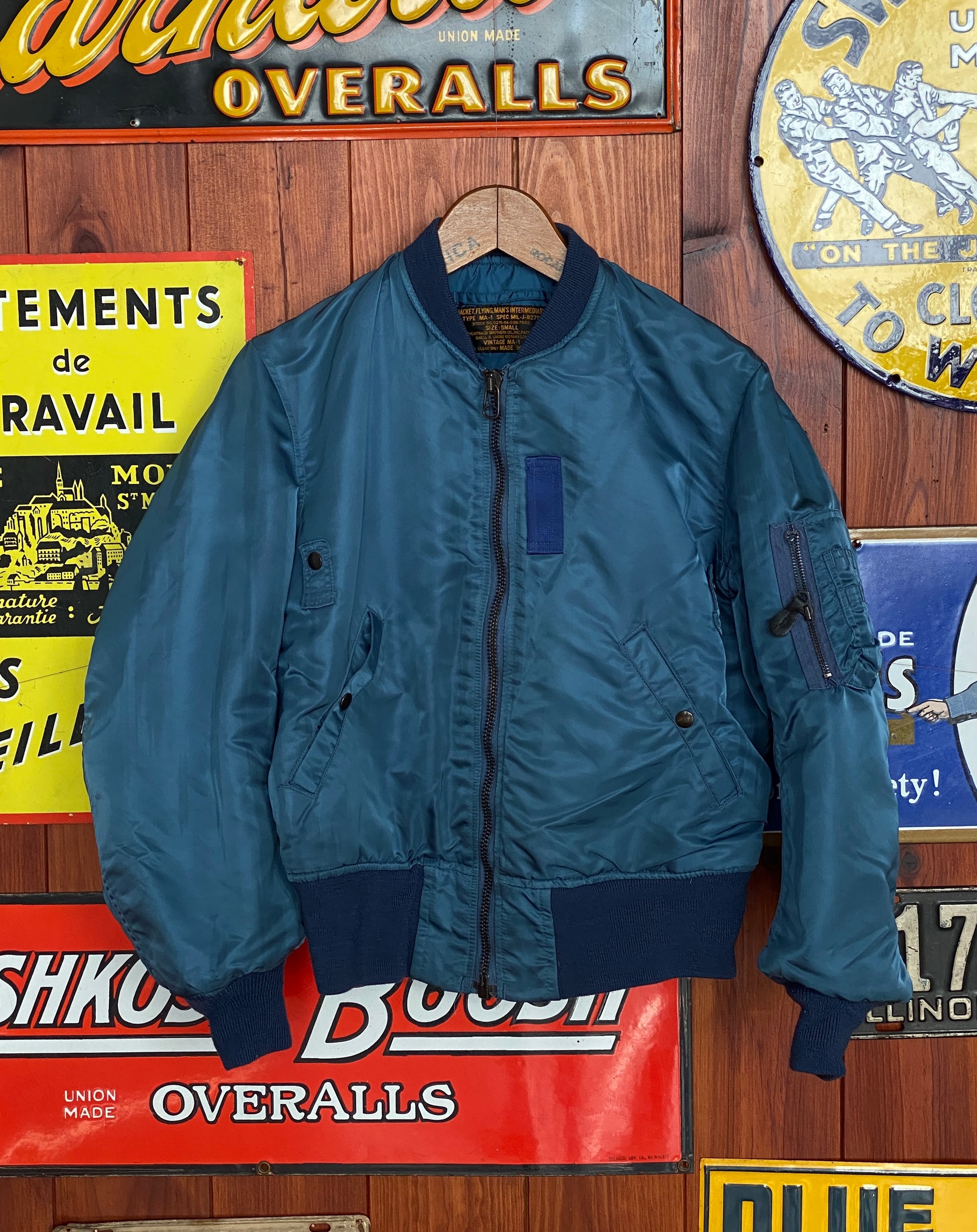 Vintage MA-1 flight bomber jacket by Weintraub Brothers, nylon shell with orange lining, size Small.