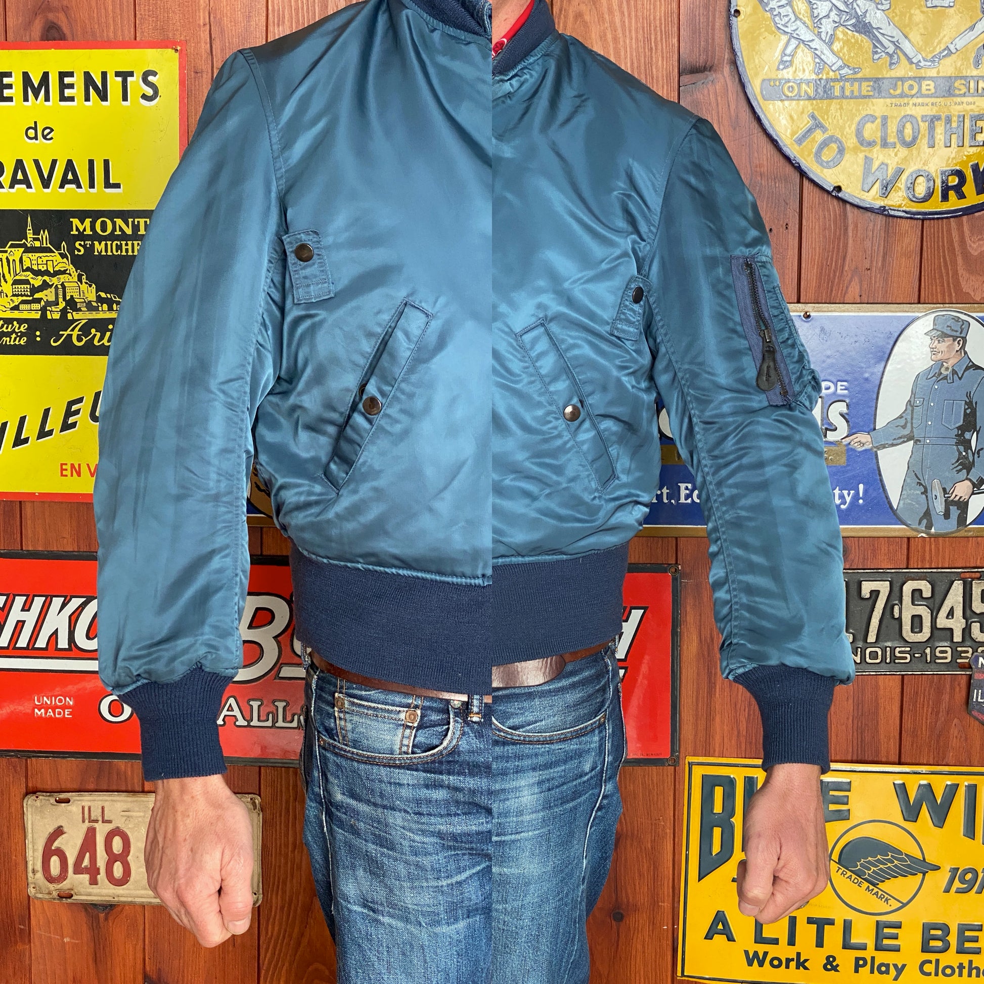 Vintage MA-1 flight bomber jacket by Weintraub Brothers, nylon shell with orange lining, size Small.