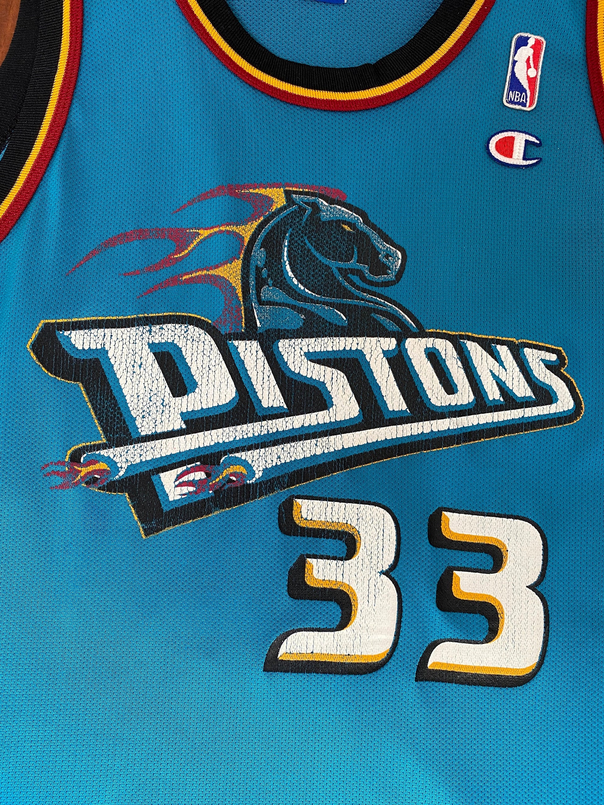 Vintage 90s NBA Champion Detroit Pistons Hill #33 jersey, size 44 - front view. Made in USA by Champion.