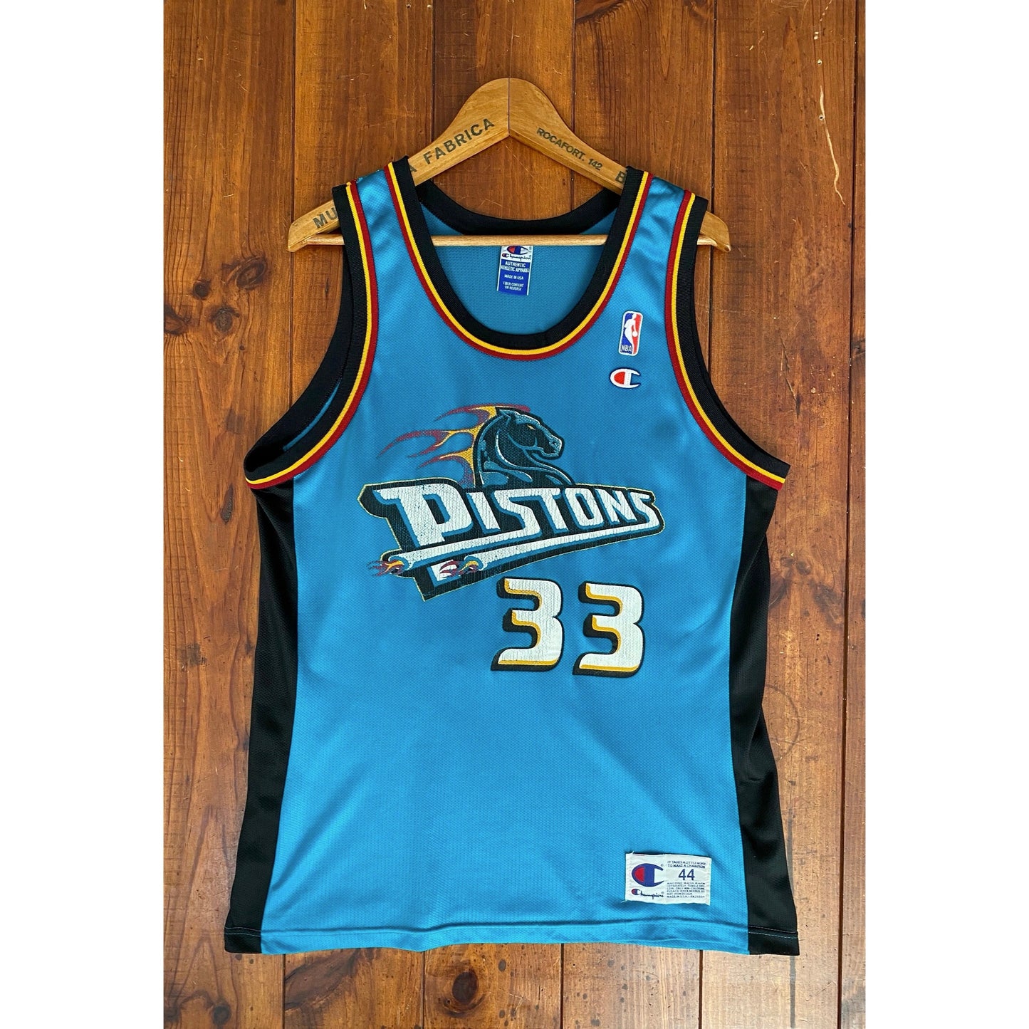 Vintage 90s NBA Champion Detroit Pistons Hill #33 jersey, size 44 - front view. Made in USA by Champion.